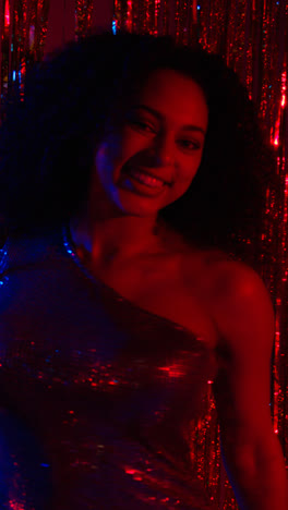 Vertical-Video-Of-Young-Woman-In-Nightclub-Bar-Or-Disco-Dancing-With-Sparkling-Lights-In-Background-6